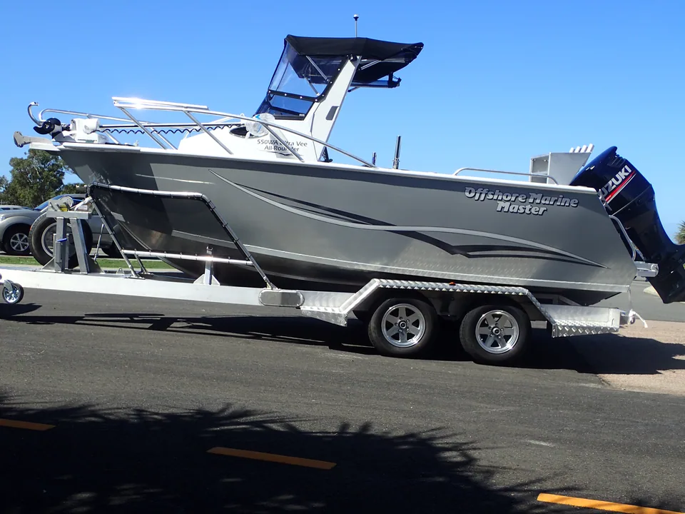 Grey soft top boat on a tandem-axle alloy trailer