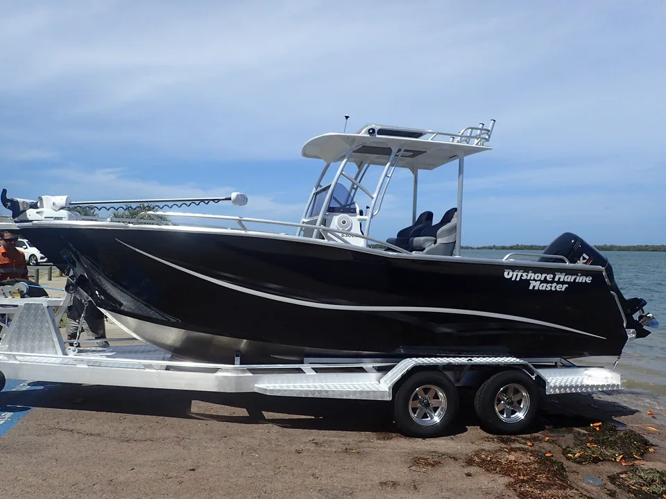 Black centre console boat with an alloy T-top on a trailer