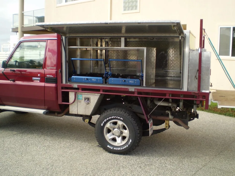 Red utility vehicle with an open alloy storage canopy