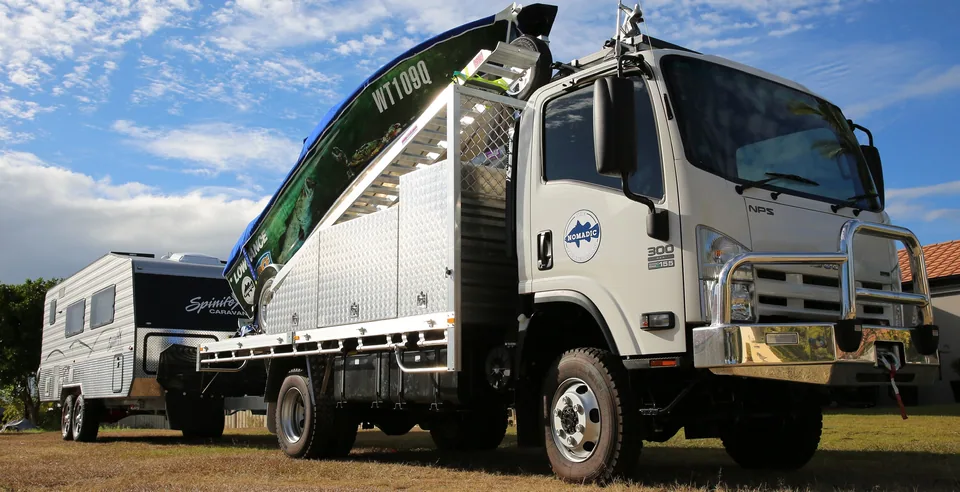Truck with checkerplate storage boxes, mounted crane and matching trailer