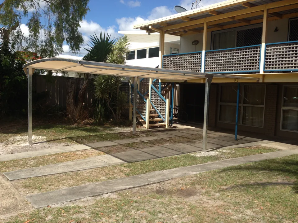 Metal-framed awning extending over a courtyard