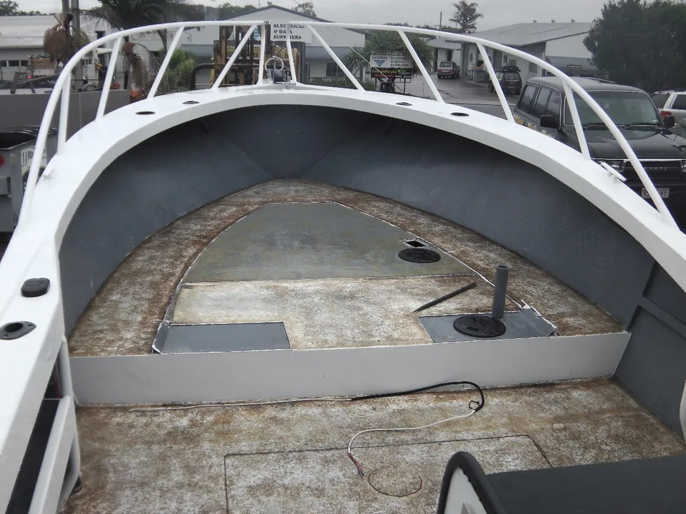 Open bow area with exposed deck panels and curved bow rails