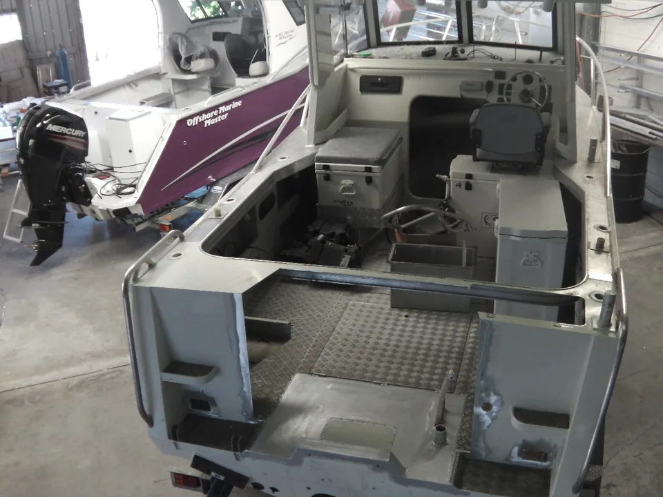 Workshop view of a boat cockpit with the centre of the transom open