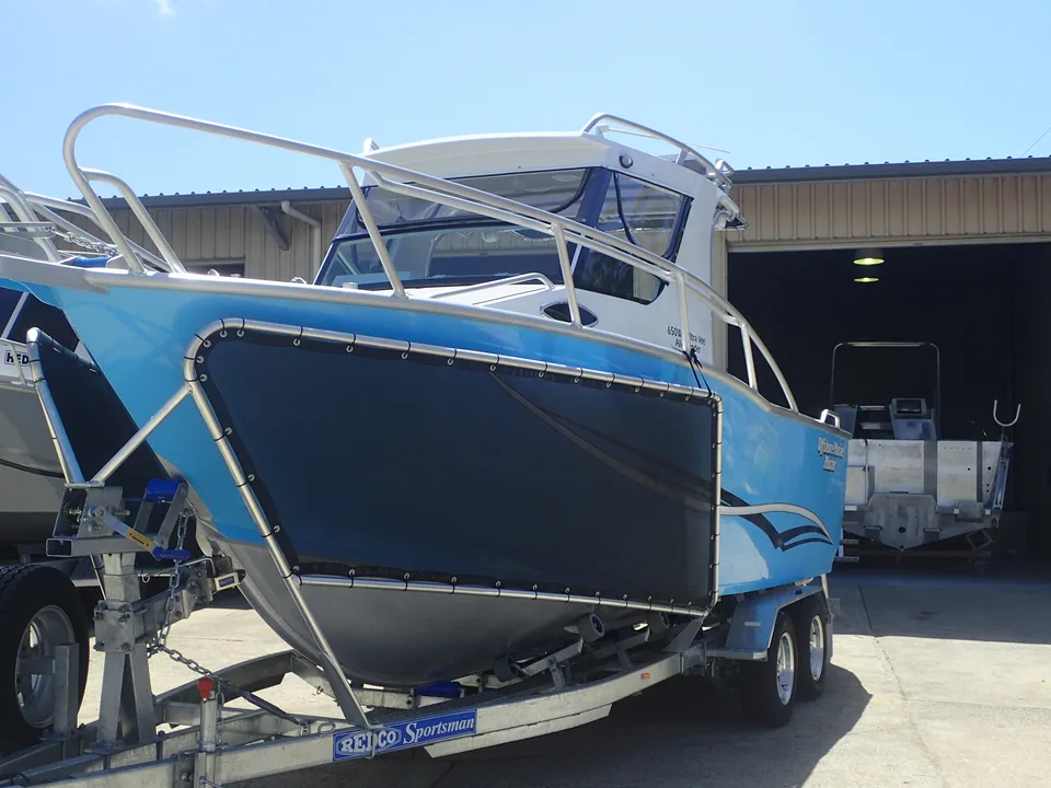 Blue boat on a trailer with a dark side stone guard