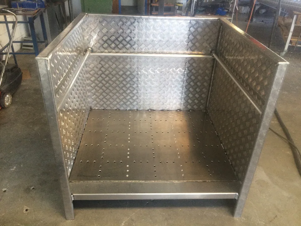 Fabricated checkerplate enclosure with handrails and a perforated floor